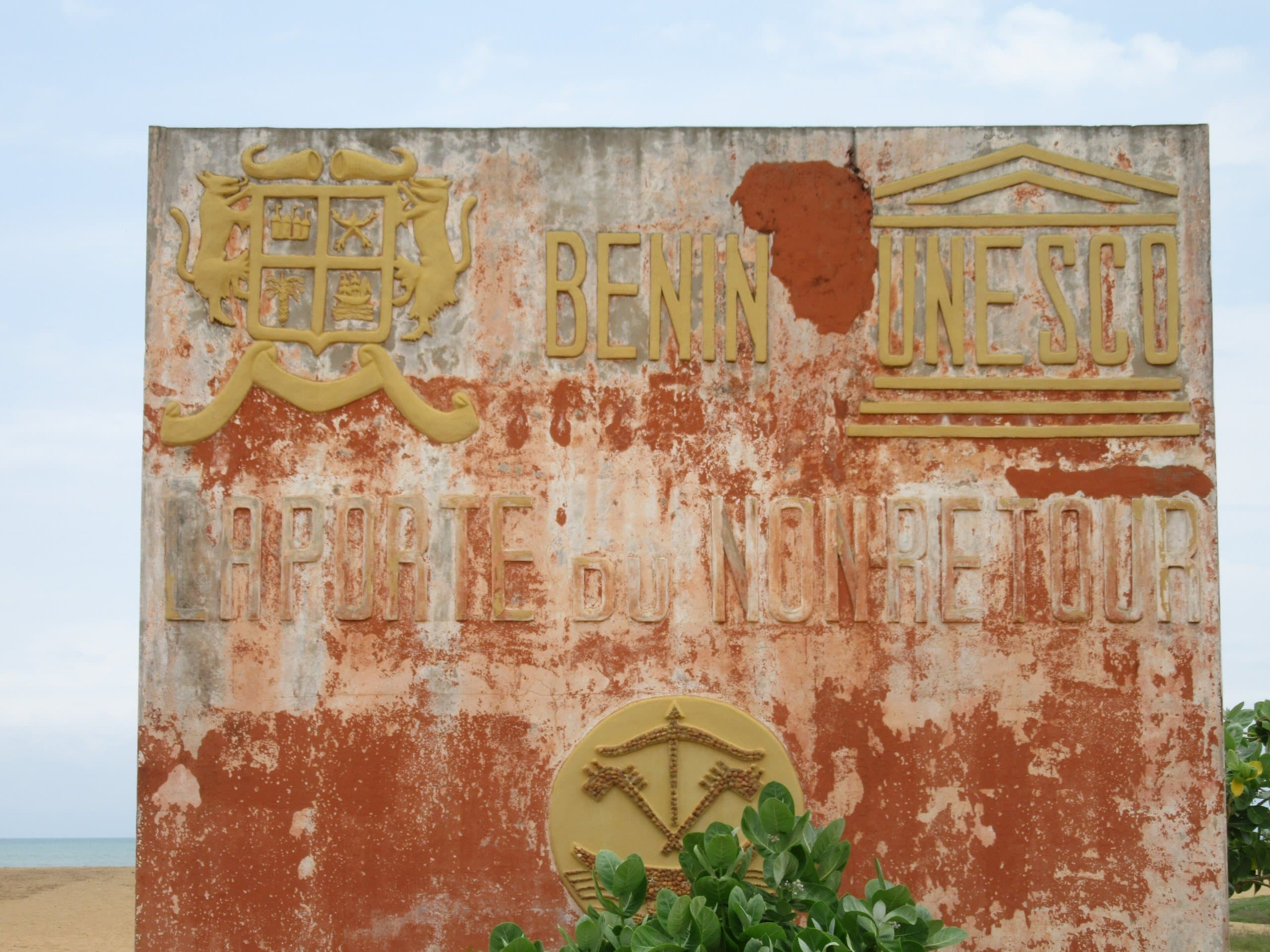 Weathered plaque reading “Benin UNESCO, the Door of No Return”